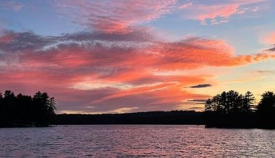 Vivid red sunset sky over Maranacook Lake