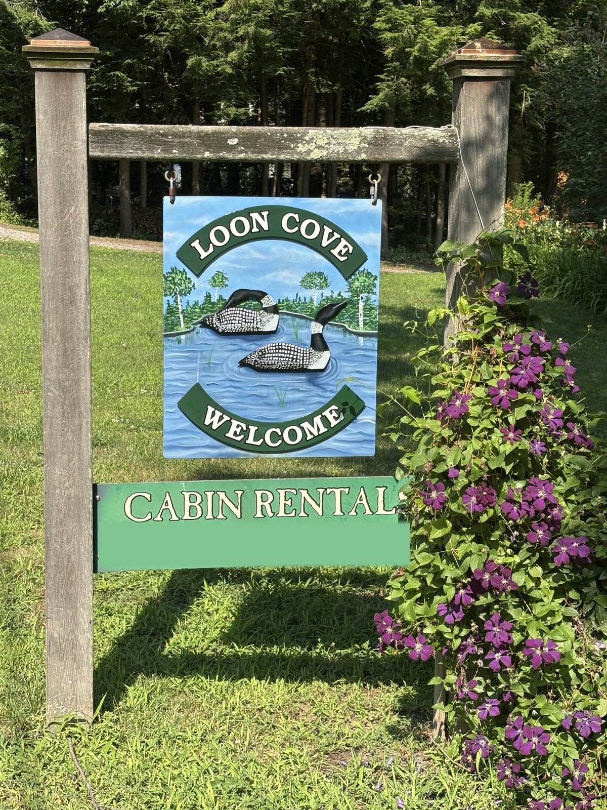 The hand-painted Loon Cove welcome sign at the entrance to the property