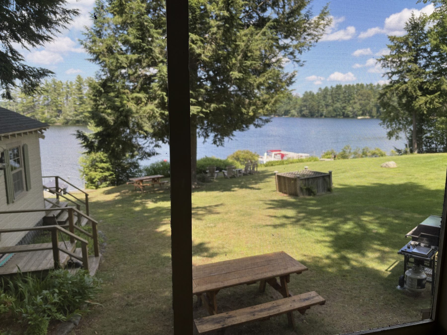 View of the lawn and lake from the screened porch