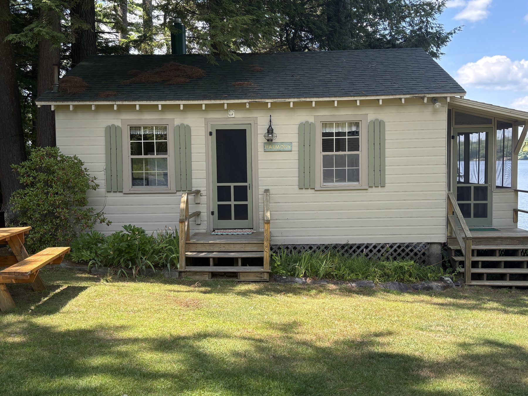 Exterior of Harmony cabin with its nameplate sign and screened porch