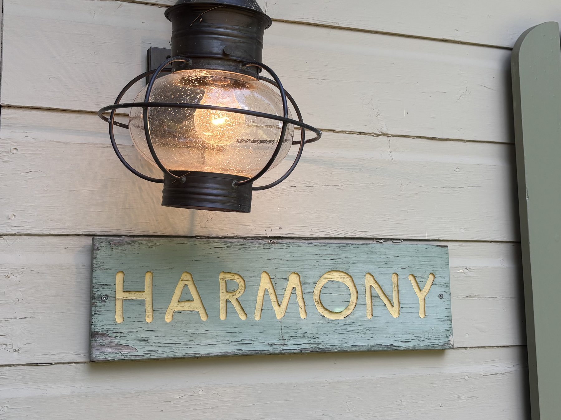 Harmony cabin nameplate sign with lantern light