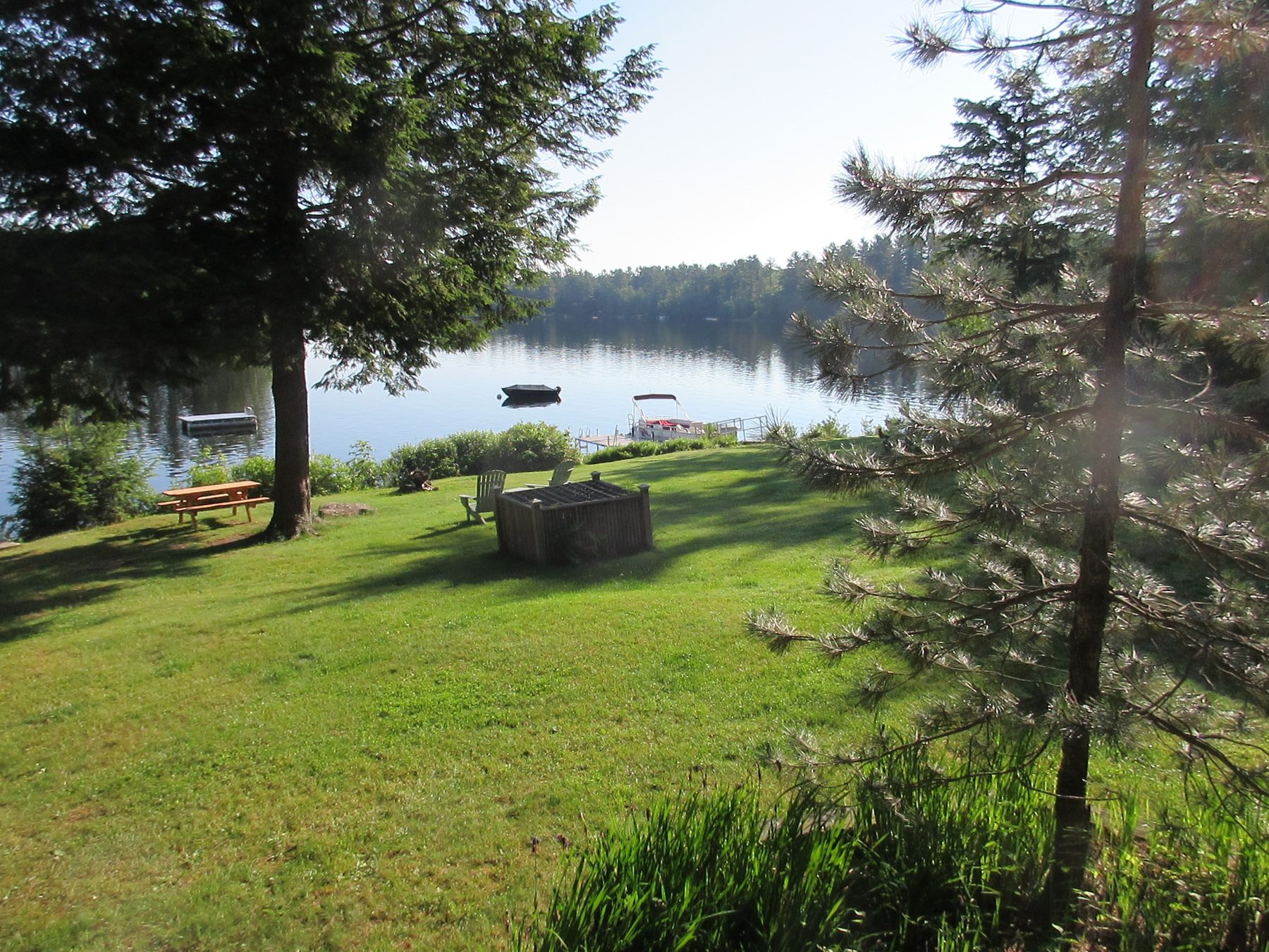 View of the dock, picnic area, and lake from the yard